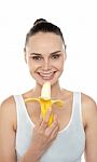 Young lady eating banana Stock Photo