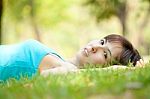 Young Lady Lying On Grass Stock Photo