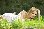 Young lady lying on grass Stock Photo