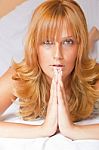 Young Lady Praying In Bed Stock Photo