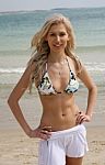 Young Lady Standing At Beach Stock Photo