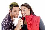 Young Male And Female Singer With Microphone Stock Photo