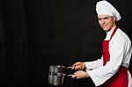 Young Male Chef Holding Empty Vessels Stock Photo