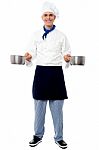 Young Male Chef Holding Empty Vessels Stock Photo