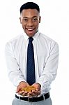 Young Male Executive Holding Gold Coins Stock Photo