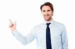 Young Male Executive Pointing Away Stock Photo