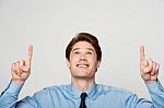 Young Male Executive Pointing Up Stock Photo