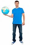 Young Male Holding Globe Stock Photo