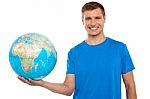 Young Male Holding Globe Stock Photo