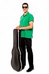 Young Male Holding Guitar Case Stock Photo