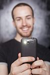 Young Male Holding Smartphone Stock Photo