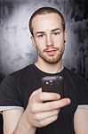 Young Male Holding Smartphone Stock Photo