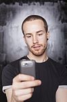 Young Male Holding Smartphone Stock Photo