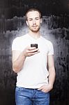 Young Male Holding Smartphone Stock Photo