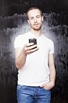 Young Male Holding Smartphone Stock Photo