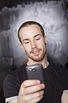 Young Male Reading Sms Stock Photo