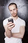 Young Male Reading Sms Stock Photo