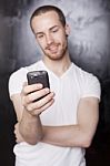 Young Male Reading Sms Stock Photo