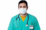 Young Male Surgeon Wearing A Face Mask Stock Photo