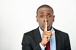 Young Male With Finger On His Lips Stock Photo