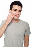 Young Man Applying Cream Lotion Stock Photo