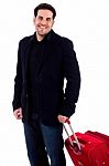 Young Man Carrying Travel Bag Stock Photo