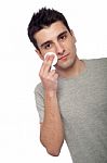 Young Man Cleaning Face Stock Photo