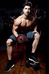 Young Man Doing Heavy Weight Exercise In Gym Stock Photo