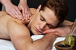 Young Man Getting Spa Massage Stock Photo