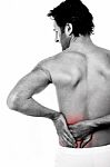 Young Man Holding His Lower Back In Pain Stock Photo