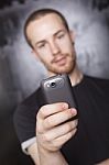 Young Man Holding Smartphone Stock Photo