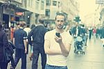 Young Man In City With Mobile Phone Stock Photo