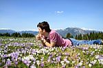 Young Man Lying Alone On Grass Stock Photo