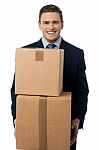 Young Man Posing With Cardboard Boxes Stock Photo