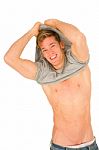 Young Man Removing T Shirt Stock Photo