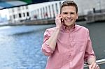 Young Man Using His Mobile Phone At Outdoors Stock Photo