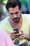 Young Man Using His Mobile Phone In The Street Stock Photo