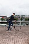 Young Man Walking With An Urban Bike Stock Photo