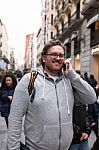 Young Man With Glasses And  Bearded Talking On His Smartphone Stock Photo