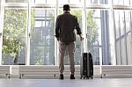 Young Man With Luggage Waiting At Airport Stock Photo