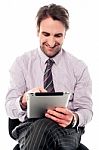 Young Man Working On Tablet Device Stock Photo