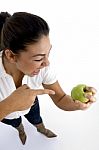 Young Model Indicating Apple Stock Photo