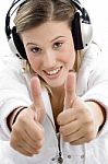 Young Model Listening Music With Headphones And Showing Thumbs Up Stock Photo