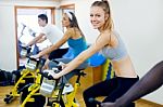 Young People With Fitness Bicycle In The Gym Stock Photo