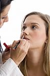 Young Pretty Beautician Applying Lipstick Stock Photo