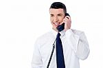 Young Professional Answering Phone Call Stock Photo