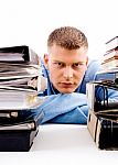 Young Professional Looking Between Files Stock Photo