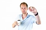 Young Salesman Holding Cup And Coffee Beans Stock Photo