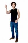 Young Smart Guy Pointing Upwards Stock Photo