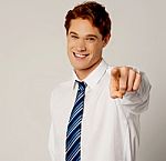 Young Smiling Businessman Pointing You Out Stock Photo